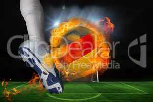 Football player kicking flaming germany flag ball