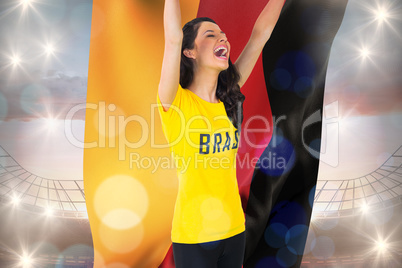 Excited football fan in brasil tshirt holding germany flag