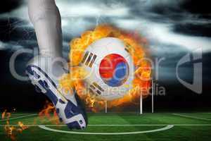 Football player kicking flaming south korea flag ball