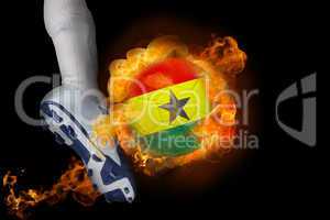 Football player kicking flaming ghana flag ball