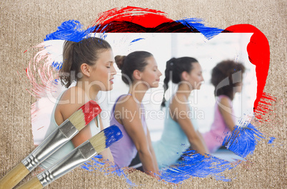 Composite image of yoga class in the gym