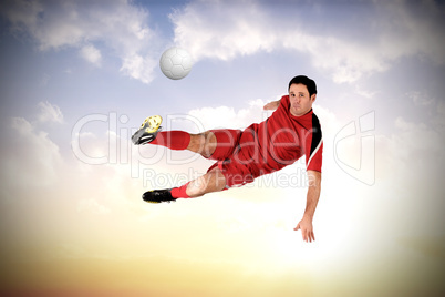 Football player in red kicking