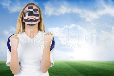 Excited greece fan in face paint cheering