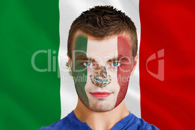 Serious young mexico fan with facepaint