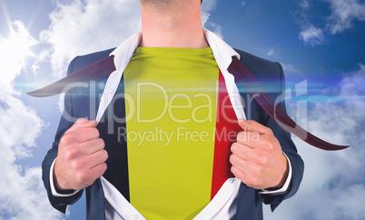 Businessman opening shirt to reveal belgium flag