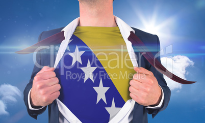 Businessman opening shirt to reveal bosnia flag