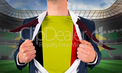 Businessman opening shirt to reveal belgium flag