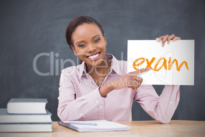 Happy teacher holding page showing exam