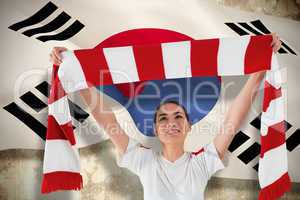 Football fan waving red and white scarf