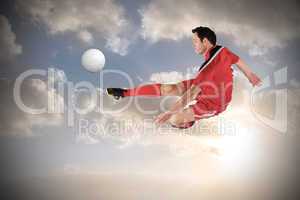 Football player in red kicking