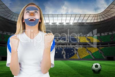 Excited argentina fan in face paint cheering