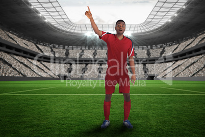 Football player in red raising his hand