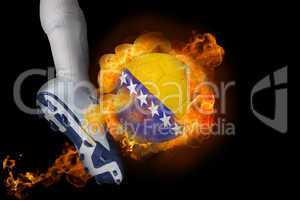 Football player kicking flaming bosnia ball