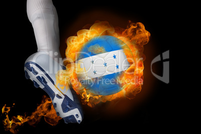 Football player kicking flaming honduras flag ball