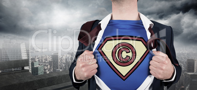 Composite image of businessman opening shirt in superhero style