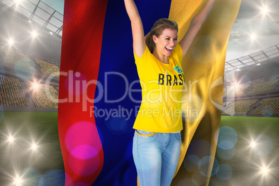 Excited football fan in brasil tshirt holding colombia flag