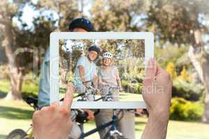 Composite image of hand holding tablet pc