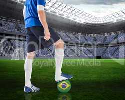 Football player standing with brasil ball