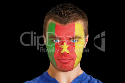 Serious young cameroon fan with facepaint