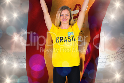 Excited football fan in brasil tshirt holding spain flag