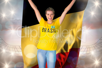 Excited football fan in brasil tshirt holding belgium flag