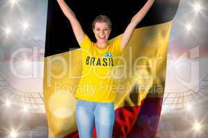 Excited football fan in brasil tshirt holding belgium flag