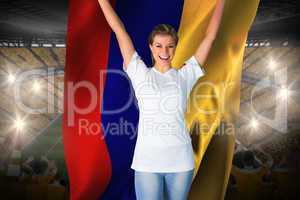 Pretty football fan in white cheering holding colombia flag
