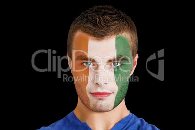 Serious young ivory coast fan with facepaint