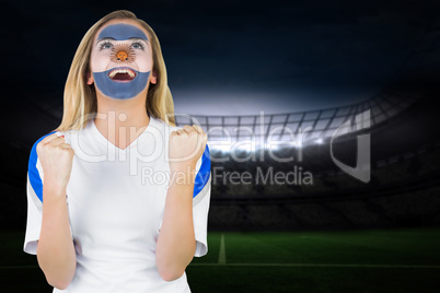 Excited argentina fan in face paint cheering