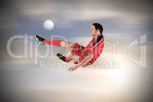 Football player in red kicking