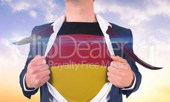 Businessman opening shirt to reveal germany flag