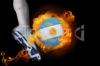 Football player kicking flaming argentina flag ball