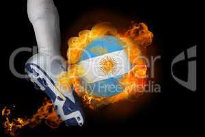 Football player kicking flaming argentina flag ball