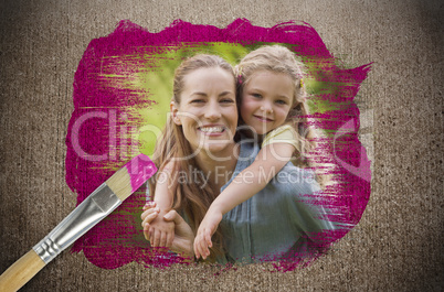 Composite image of mother and daughter with paintbrush dipped in pink paint