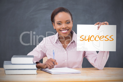 Happy teacher holding page showing success