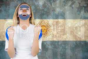 Excited argentina fan in face paint cheering