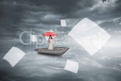 Composite image of attractive businesswoman holding red umbrella