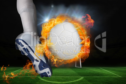 Football player kicking flaming ball