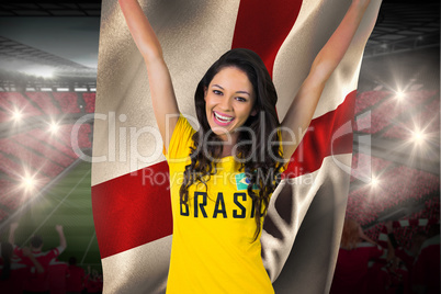 Excited football fan in brasil tshirt holding england flag