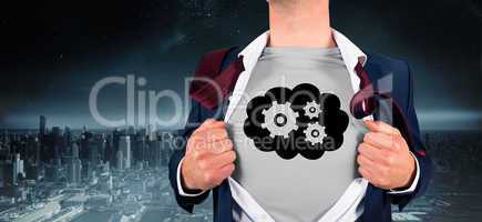 Composite image of businessman opening shirt in superhero style