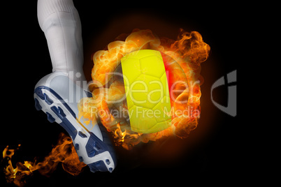 Football player kicking flaming belgium ball