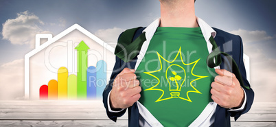 Composite image of businessman opening shirt in superhero style