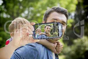 Composite image of hand holding smartphone showing