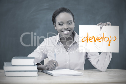 Happy teacher holding page showing develop