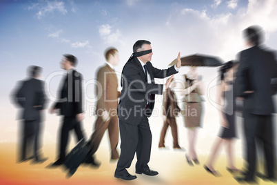 Composite image of mature businessman in a blindfold