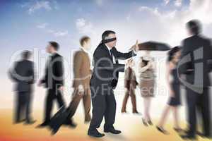 Composite image of mature businessman in a blindfold