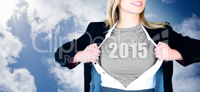 Composite image of businesswoman opening shirt in superhero styl