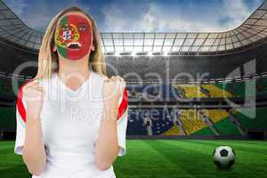 Excited portugal fan in face paint cheering