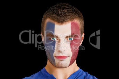 Serious young france fan with facepaint