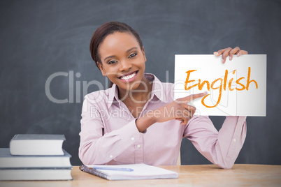 Happy teacher holding page showing english